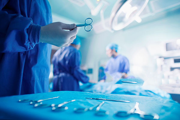 Doctors performing surgery in hospital operating room